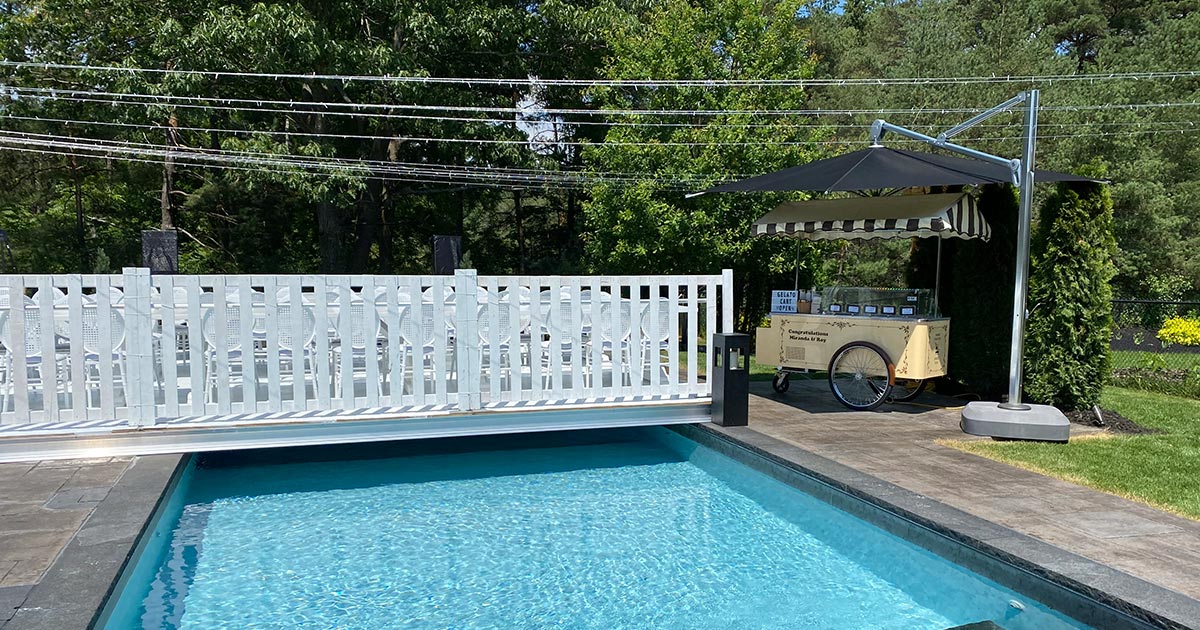 Vintage Gelato Cart set up next to inground pool with white chairs in rows