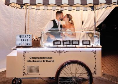 Bride and Groom kissing behind a Vintage Gelato Cart