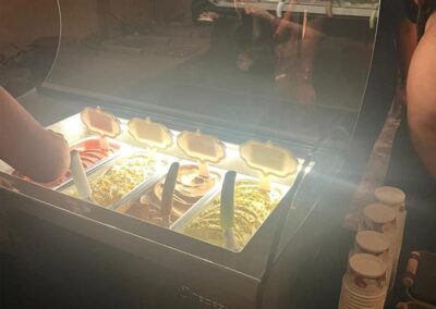 View of open tabletop with staff scooping into cup