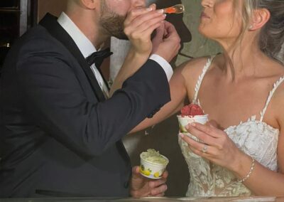 Bride & Groom feeding each other gelato at wedding