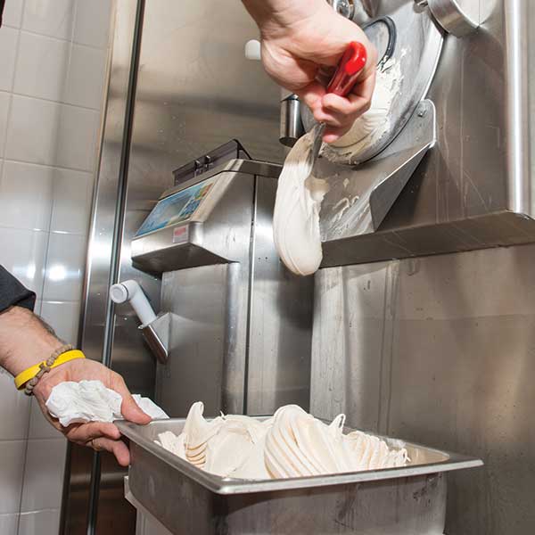 Gelato coming out of machine and collected in pan
