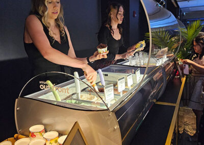 Hospitality staff scooping gelato for guests