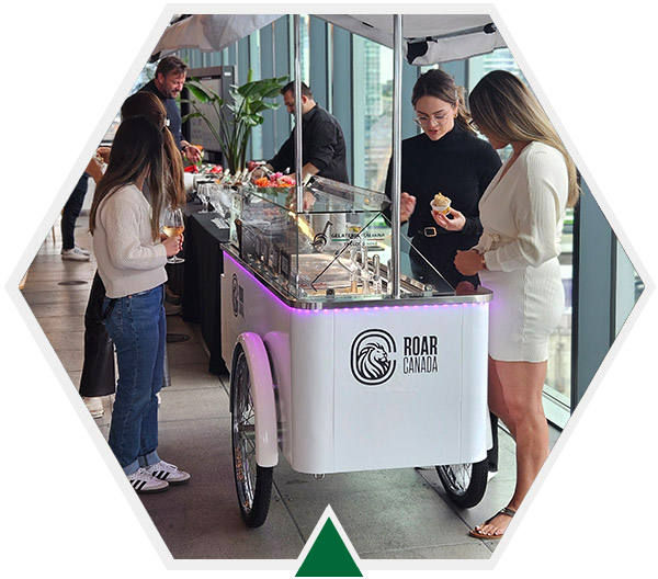 Side view of white vintage gelato cart showing ROAR logo with guests choosing flavours