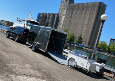 Unloading the White Vintage Cart with Escalade and Trailer on dock