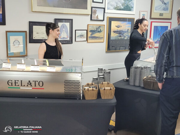 Two tables with two Gelato Tabletops and two women standing behind ready to serve